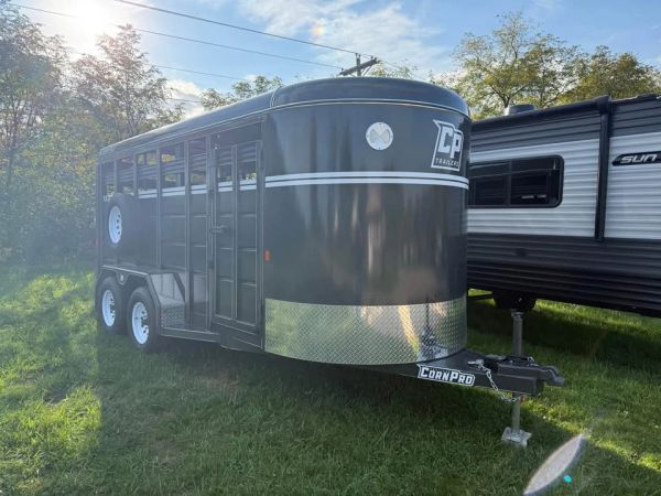 Black CornPro CP Trailer parked on grass.