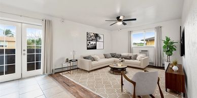 Bright, modern living room with sectional sofa and wall art.