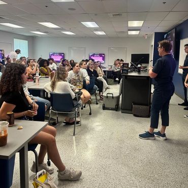 Professor Eileen Acello speaking to students at an AMA meeting.