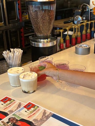 Girl grabbing a drink from a bar.
