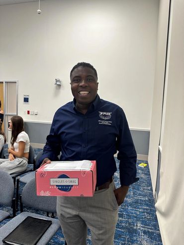 Man holding merchandise box at AMA meeting.