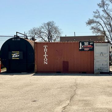 Industrial containers and equipment for sealing supply services under clear sky.