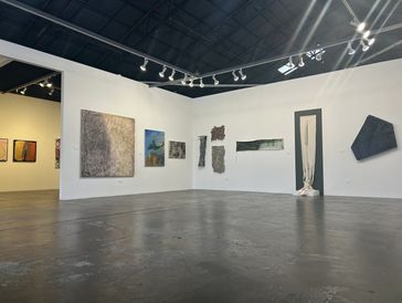 Art gallery with abstract paintings and sculptures.