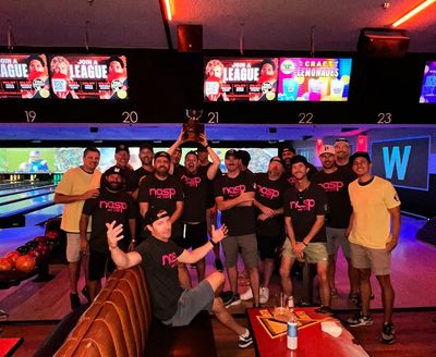 Group of friends celebrating at a bowling alley.