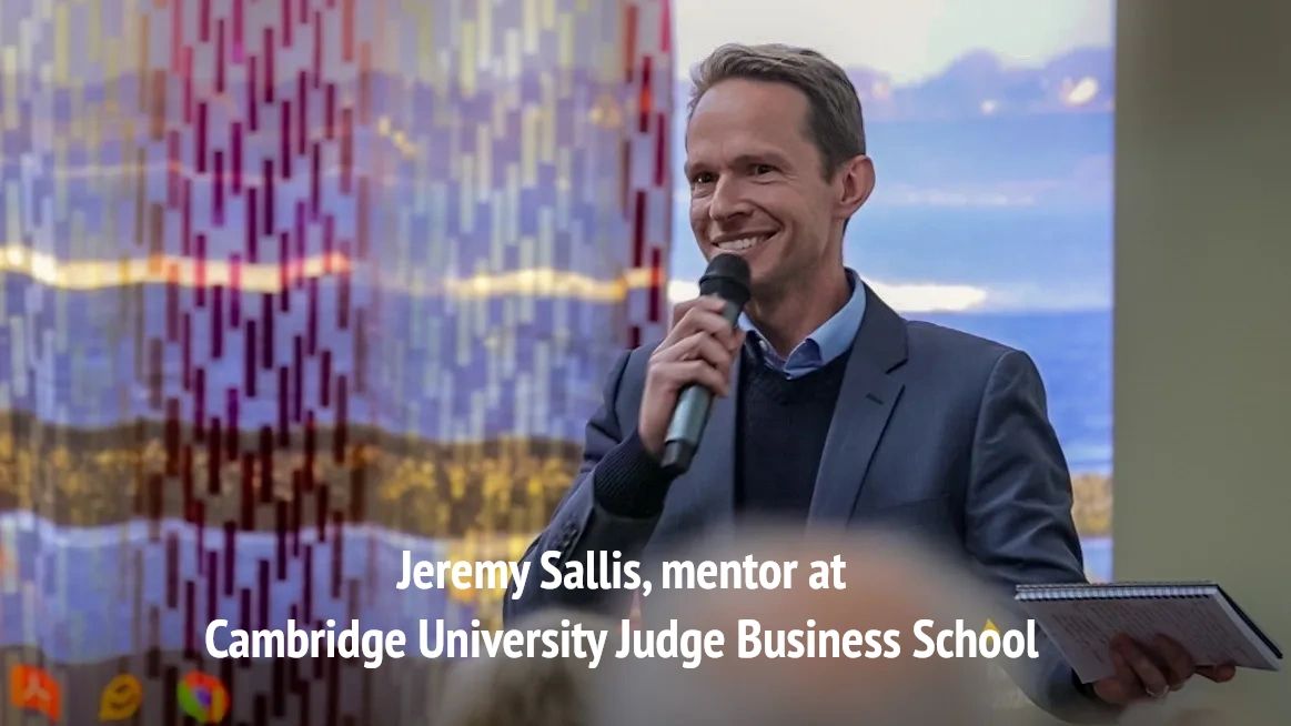 Presentation skills coach Jeremy Sallis holding a microphone and delivering a training course.