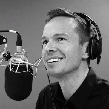 Former BBC Radio Cambridgeshire and Look East presenter Jeremy Sallis behind a studio microphone