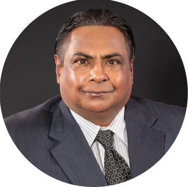 Professional portrait of a man in a suit and tie against a black background.