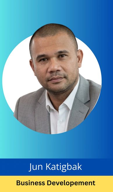 Professional portrait of Jun Katigbak in a gray suit.