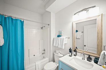 First floor full bathroom with shower tub combo and vanity at Serenity Cove