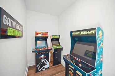Dedicated retro arcade room with classic video game cabinets at Serenity Cove