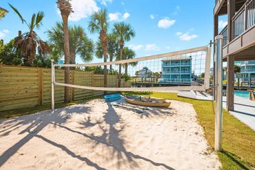 Private sand volleyball court in the backyard of Serenity Cove luxury vacation home