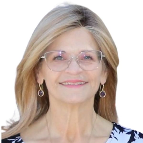 Smiling woman with glasses and purple earrings against a white background.