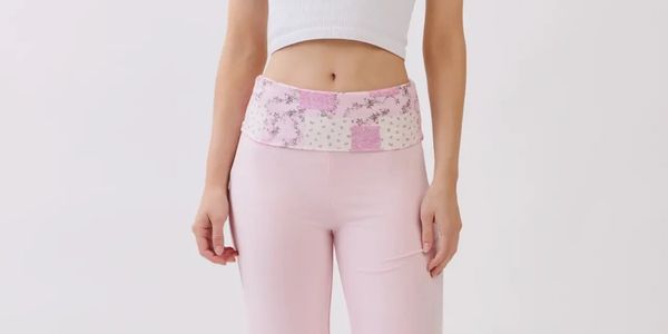 Person wearing pink pants with a patchwork waistband and white crop top.