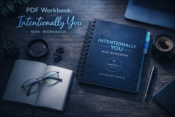 A workspace with the Intentional You mini-workbook and writing essentials.