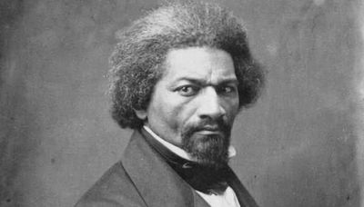 Portrait of a serious man with afro hair and a goatee.