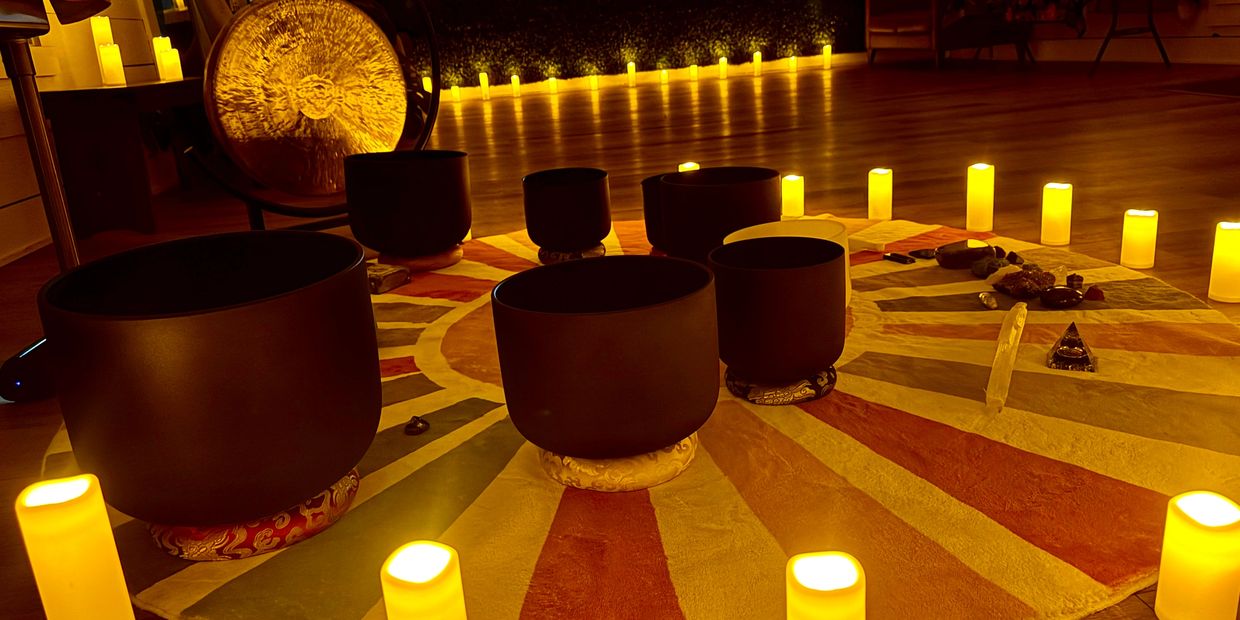 Sound bowls and candles set in a circle for meditation.
