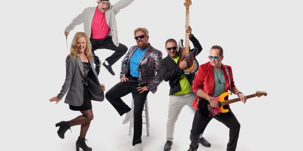 Energetic band posing with instruments and lively expressions.