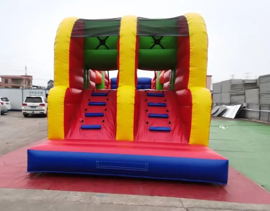 Colorful inflatable climbing slide with red, yellow, blue, and green sections.