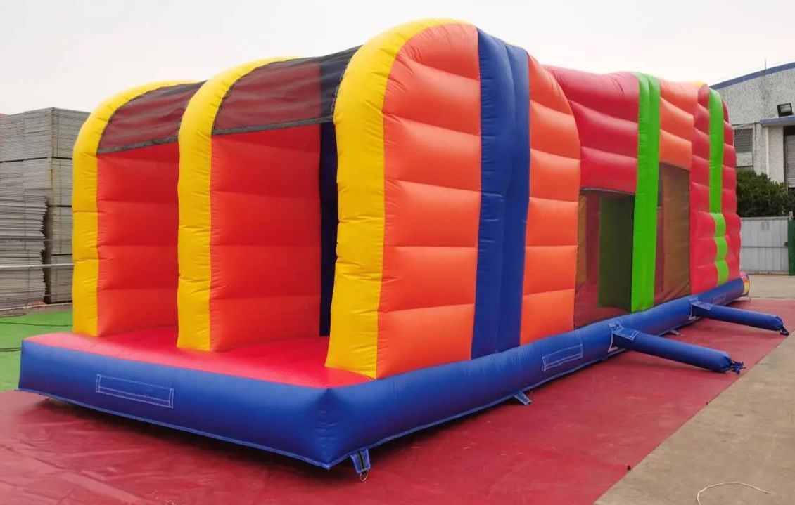 Large colorful inflatable obstacle course set up outdoors.