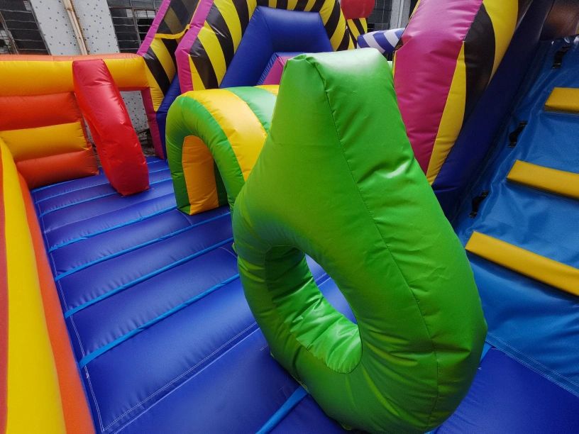 Colorful inflatable obstacle course with various shapes and bright colors.