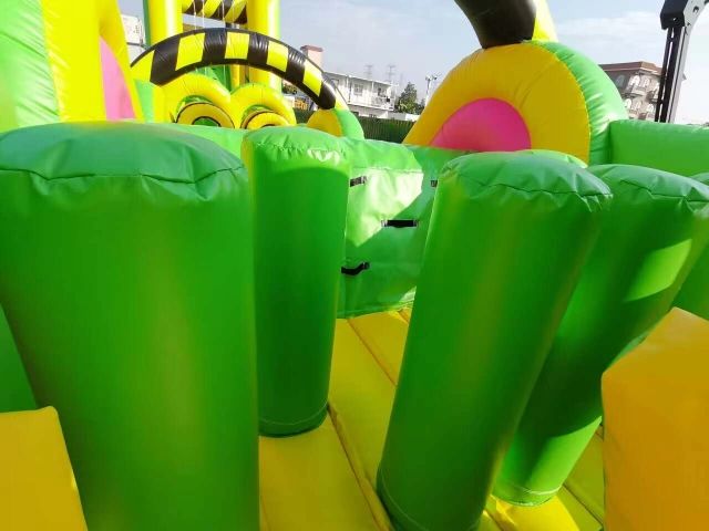 Close-up of a green inflatable obstacle course section.