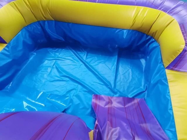 Empty colorful inflatable pool with blue, yellow, and purple sections.