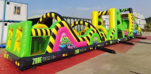 Colorful inflatable obstacle course set up outdoors under clear sky.