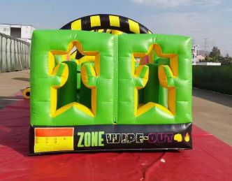Bright green inflatable game with star-shaped cutouts for a fun activity.