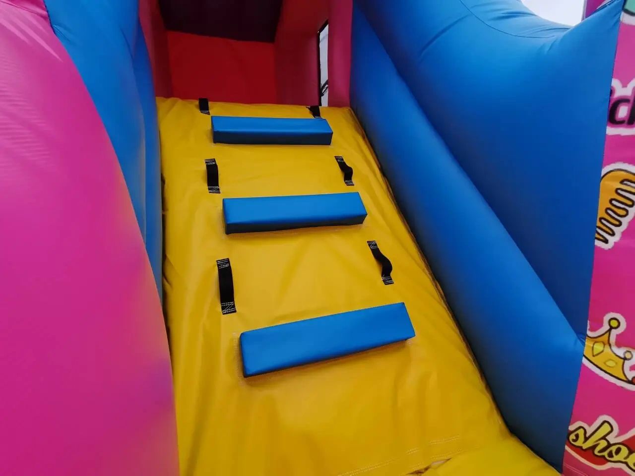 Colorful inflatable climbing wall with blue steps and yellow base.