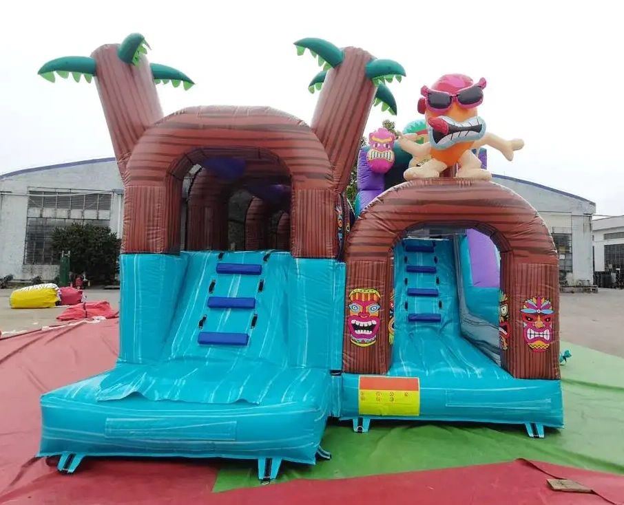 Colorful inflatable water slide with tropical and tiki theme.