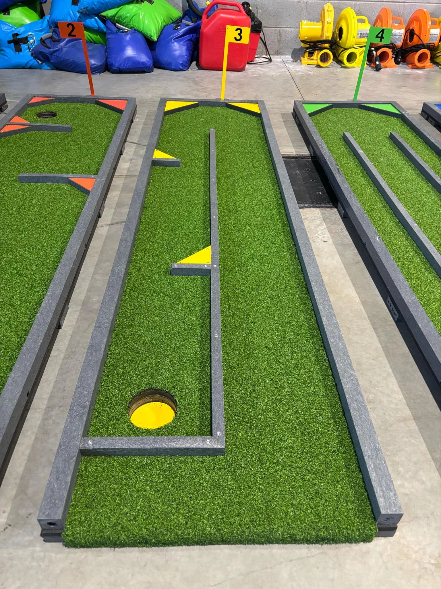 Mini golf holes 2, 3, and 4 with colorful markers and obstacles.