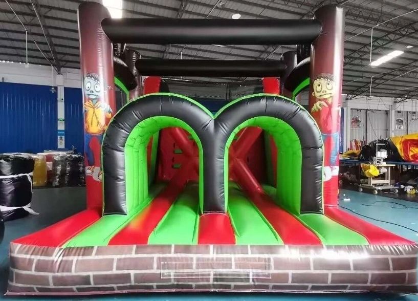 Colorful inflatable obstacle course with tunnels inside an indoor facility.