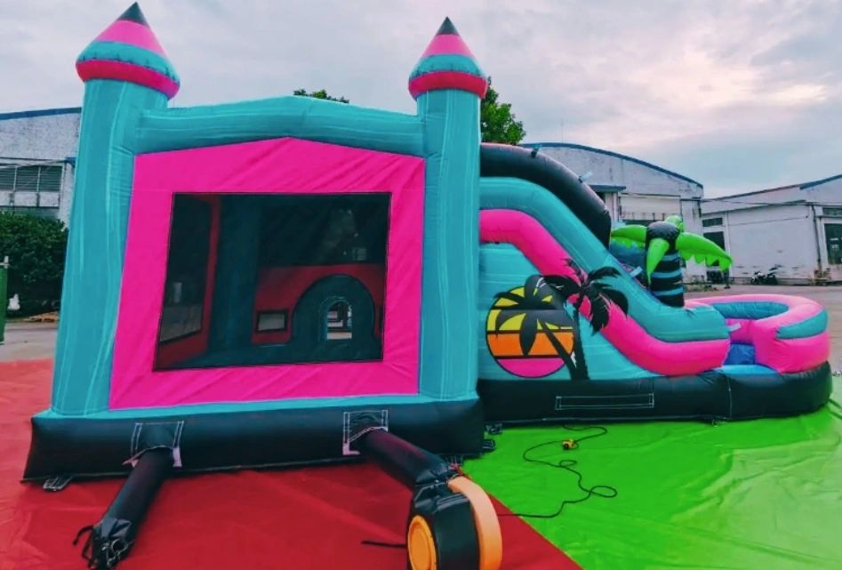 Colorful inflatable bounce house and slide set up outdoors.