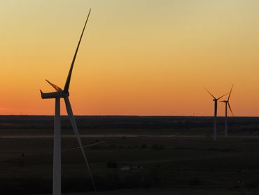 A wind turbine at dusk in an aerial photo in Texas by Andy LaViolette.