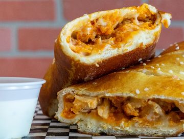 Close-up of a stuffed bread with sauce.