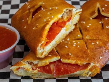 Pepperoni calzone with marinara sauce.