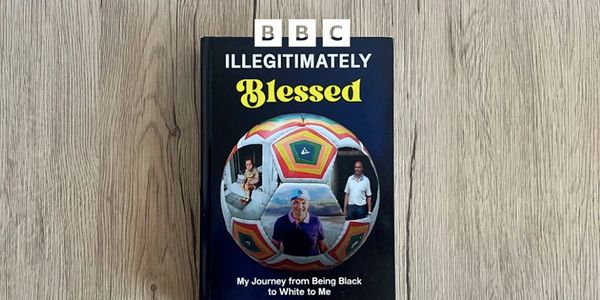 Book titled 'Illegitimately Blessed' on a wooden surface.