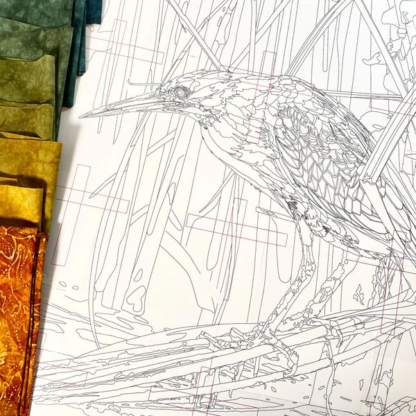 Uncolored detailed bird illustration beside arranged fabric pieces.