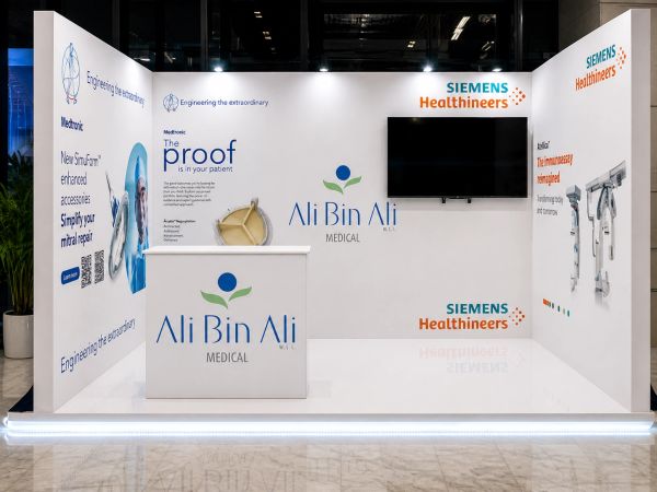 Exhibition booth featuring Ali Bin Ali Medical and Siemens Healthineers branding with medical equipment displays.