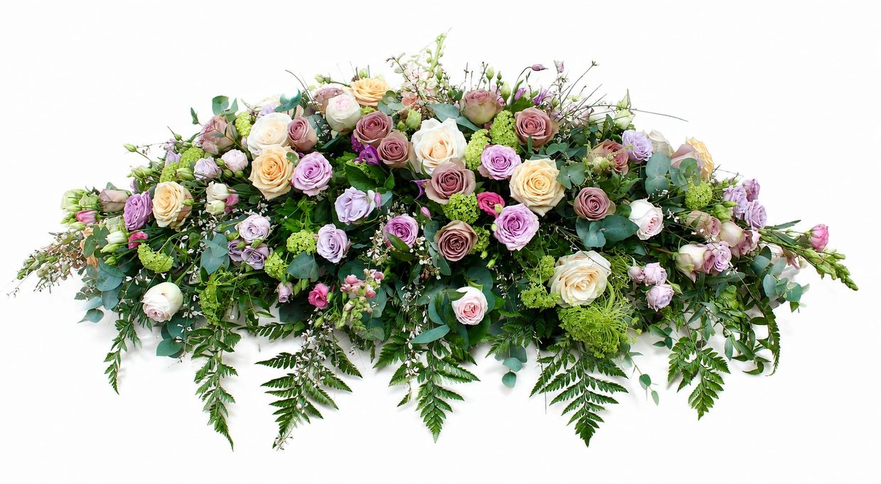 Elegant floral arrangement with pastel roses and lush greenery.