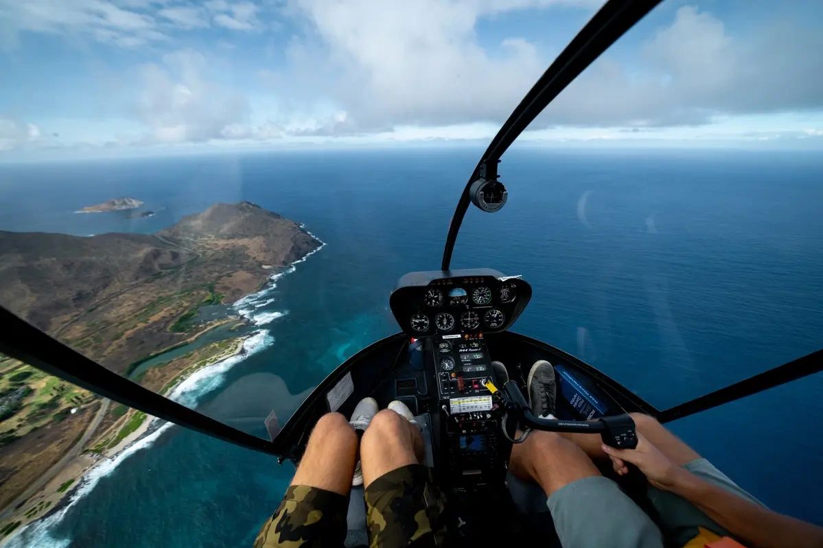 Helicopter cockpit view of southeast Oahu’s coastline and blue ocean