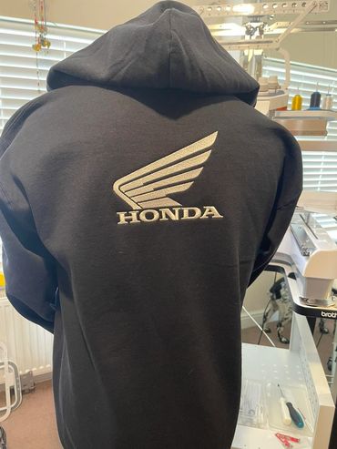 Black jacket with artistic printed elements.