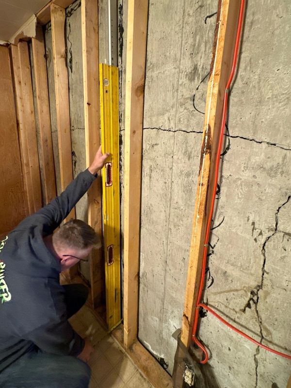 Steven Ostapiw from K&S Contracting Inc assessing a cracked foundation