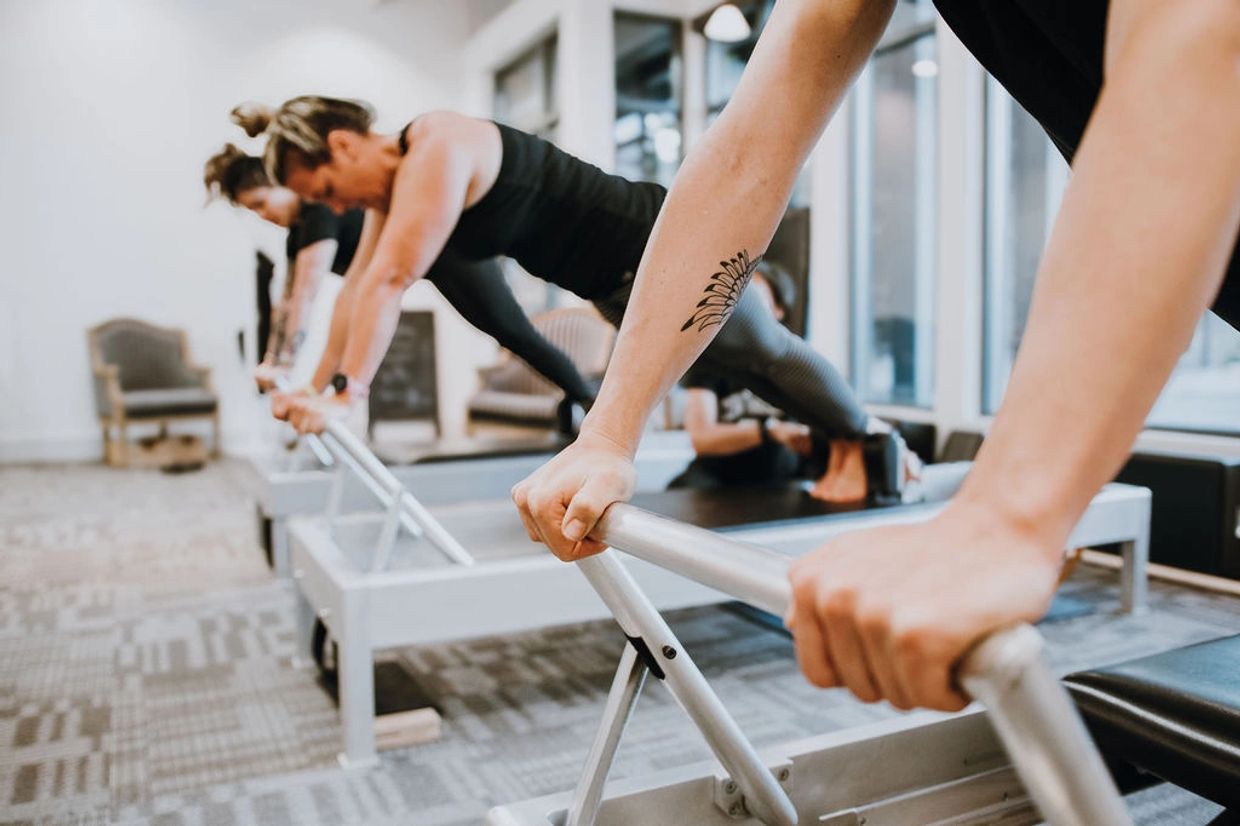 Women exercising on Pilates reformer during a private Pilates session