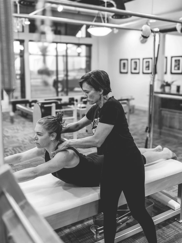 Juanita Ostrem teaching pilates on the cadillac
