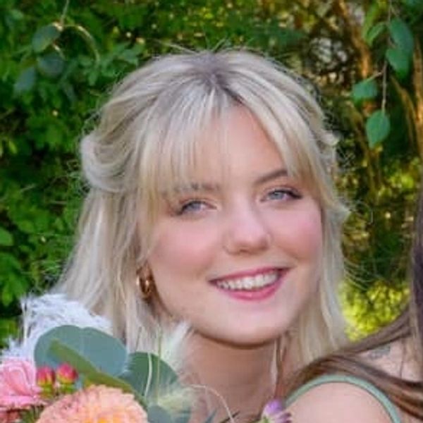 a smiling woman with long blonde hair