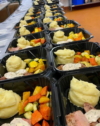 Boxed dinner with pork tenderloin, fresh seasonal vegetables and mashed potatoes.