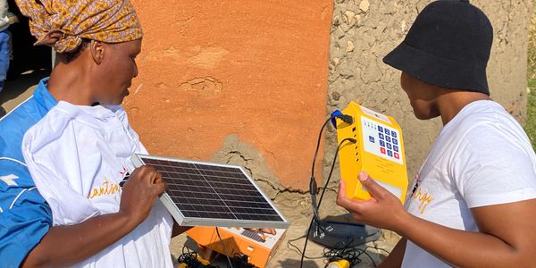 professionals installing a solar panel.