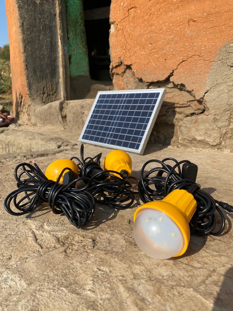 a solar panel connected to lots of light bulbs.