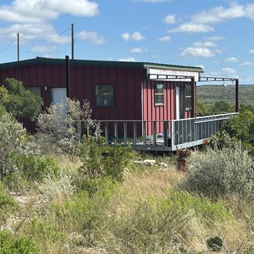 Small red cabin with po